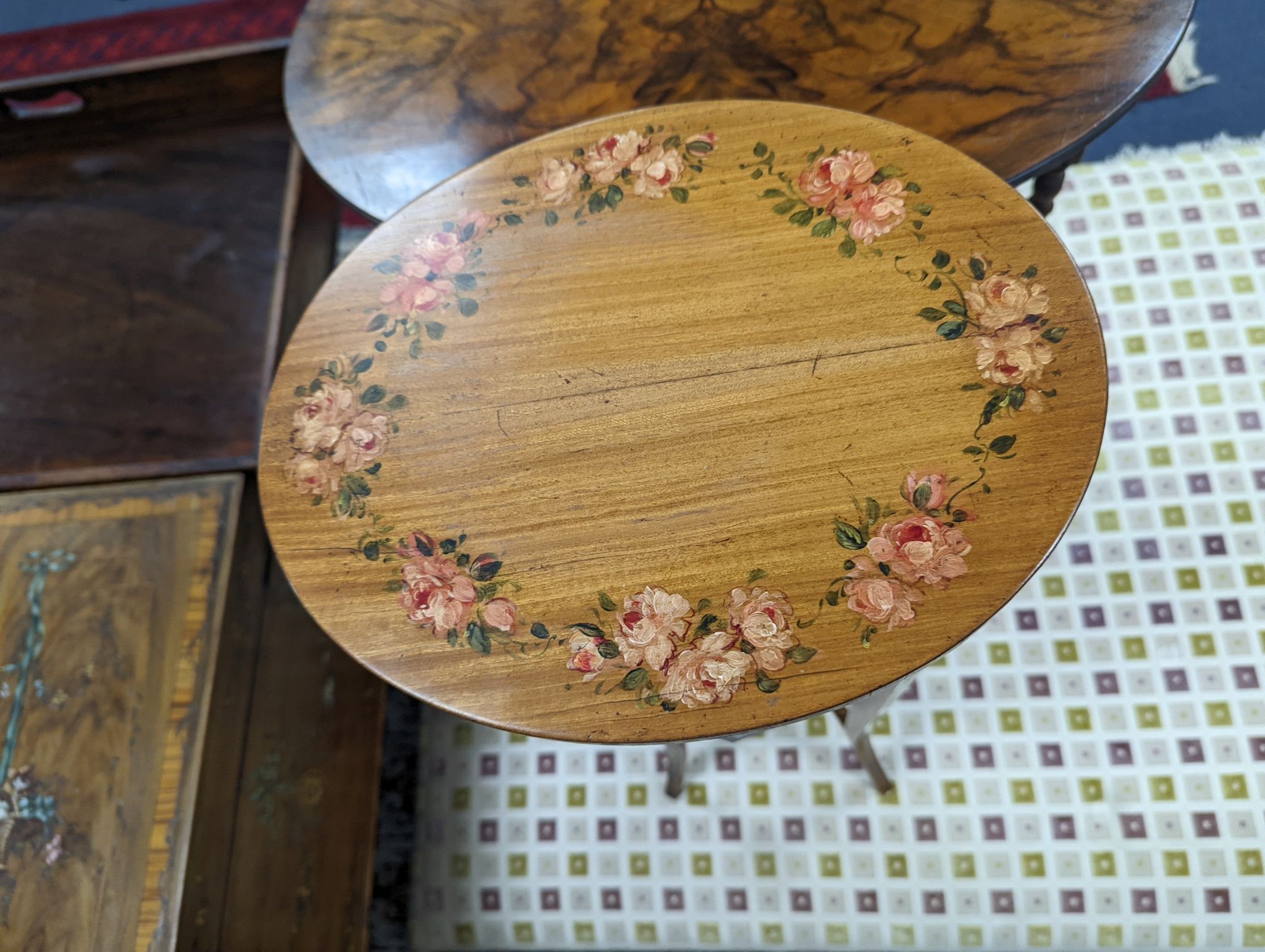 A small Sheraton style oval painted satinwood two tier plant stand, width 30cm, depth 25cm, height 73cm